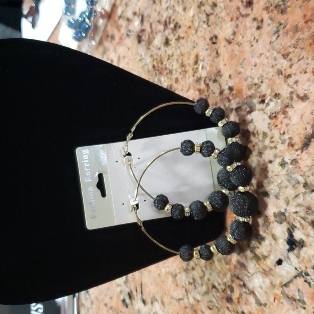 Gold tone earrings with black mesh balls & gold tone spacers with clear stones.